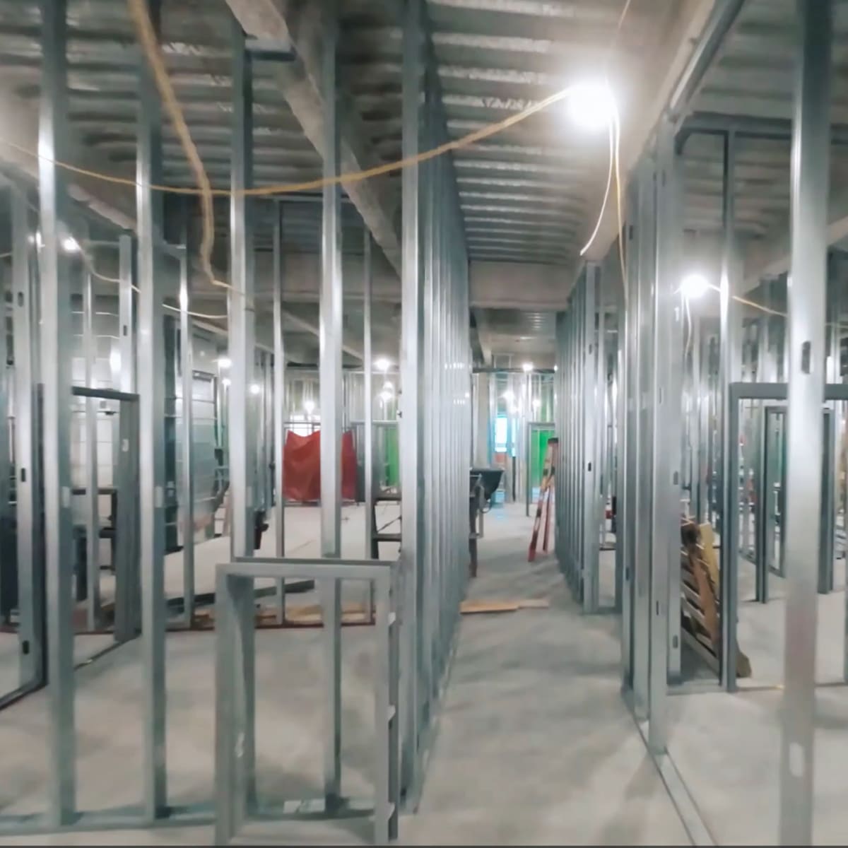 Electrical contractors discuss plans in a new construction home.