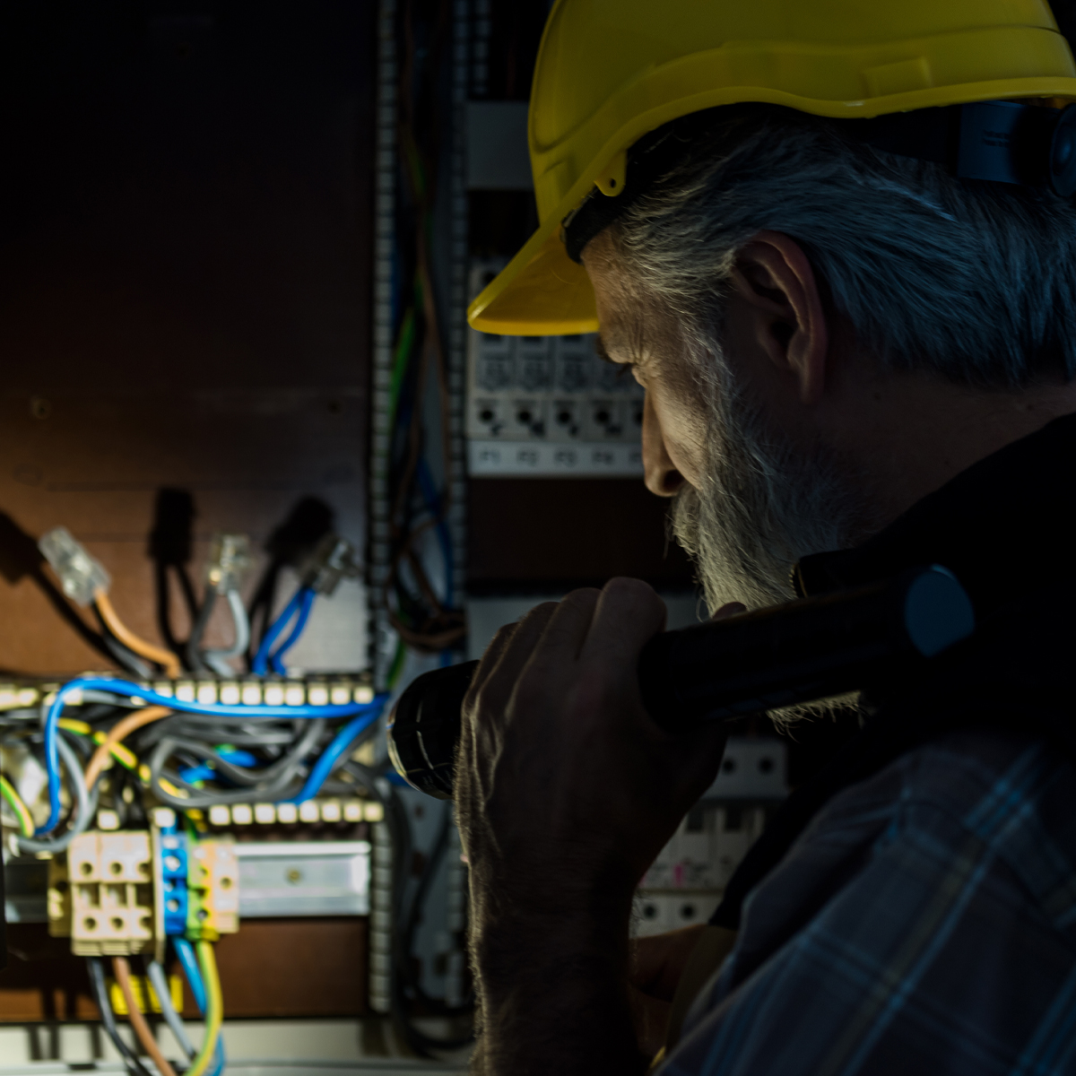 Electrical contractors discuss plans in a new construction home.